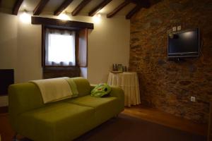戈伊什Casa do Neveiro的客厅配有绿色沙发和电视
