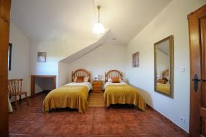 卡尔瓦略Hotel Mar de Queo的一间设有两张带黄色毯子的床的房间