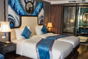 老街市Michi's hotel laocai的酒店客房配有一张带蓝色枕头的大床