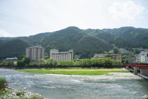 下吕市水明馆酒店的一条城市和山脉为背景的河流