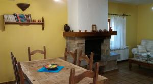 Casas del MonteLa Casa de la Abuela的一间带桌子和壁炉的用餐室