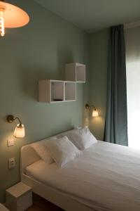萨格勒布SMILE&LOVE REPUBLIC ZAGREB CENTER的一间卧室配有一张带两个灯的床