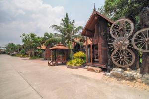 Ban Tha SaiSuankaew Art Cottage的街道旁有两轮大轮的建筑物