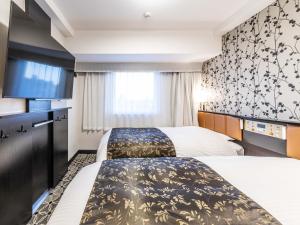 APA Hotel & Resort Ryogoku Eki Tower客房内的一张或多张床位