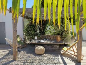 雷岛林滩Derrière la plage : suite, patio et pergola的一个带长凳和树的庭院