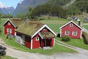 BriksdalsbreTrollbu Aabrekk gard的两座红色建筑,屋顶上有草