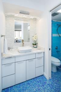 檀香山Waikiki Banyan Modern One Bedroom Free Parking的白色的浴室设有水槽和卫生间。