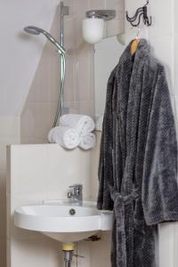 威廉斯塔德Pure Passie Bed and Breakfast的浴室设有挂在水槽上的毛巾