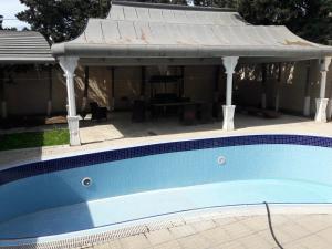 马达肯Mardakan Cottage House的一个带屋顶凉亭的游泳池