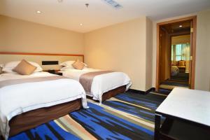 深圳深圳凯利宾馆（近罗湖口岸，东门步行街，国贸商圈）的一间酒店客房,设有两张床和走廊