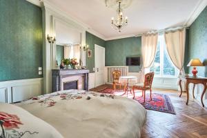BarbevilleChateau des Monts的卧室配有一张床和一张桌子及椅子