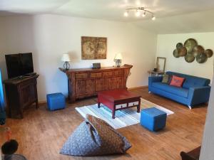 RanconGite La Grange de Jeanne的客厅配有蓝色的沙发和电视