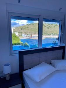 萨兰达Fabeno Villa的一间卧室设有2扇窗户,享有水景