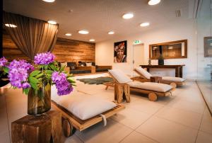 斯拉德明Sun Lodge Schladming by Schladming-Appartements的客厅配有沙发和紫色花瓶