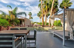 斯科茨浩谷酒店的一个带桌椅和棕榈树的庭院