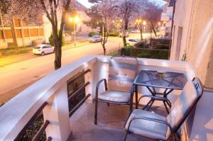 萨格勒布马克西米1号苏伯公寓的阳台配有桌椅和街道