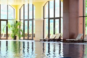 普拉韦茨Hyatt Regency Pravets Resort的大堂设有游泳池、椅子和窗户
