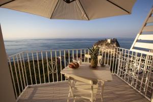 特罗佩阿Le Tolde del Corallone的阳台配有桌子,享有海景。