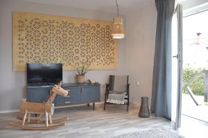 VisokoLesnavesna designer Apartment with a garden的一间带电视和玩具长颈鹿的客厅