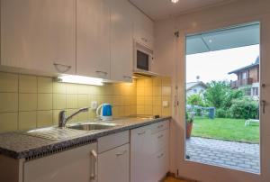 莱克斯Grava - Ferienwohnung für max. 2 Personen的一个带水槽和大窗户的厨房