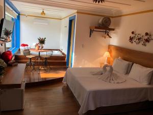 欧鲁普雷图Hotel Recanto do Ouro - Antigo Recanto da Serra的卧室配有一张床和一张桌子