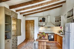 卡涅利亚斯Villa Hermosa at Masia Nur Sitges, Adults only的厨房配有白色橱柜和木制台面