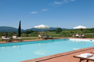 博尔戈圣洛伦索Monsignor Della Casa Country Resort & Spa的一个带椅子和遮阳伞的大型游泳池