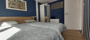 德哈恩Seagarden by Valdemosa的一间卧室设有一张床和蓝色的墙壁