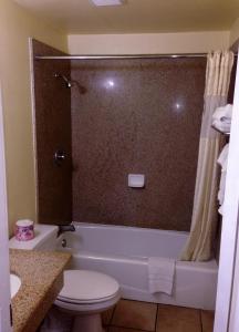 圣贝纳迪诺市中心7号汽车旅馆的带浴缸、卫生间和淋浴的浴室。