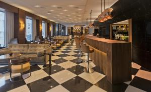 海若克利欧拉奎拉亚特兰蒂斯酒店的大堂设有带沙发和椅子的酒吧