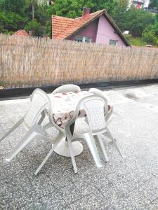 乌日策Dvosoban stan的庭院里设有两把椅子和一张桌子
