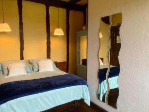 Ziga波萨达泽加旅馆的一间卧室配有一张带蓝色床单和白色枕头的床。