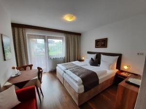 菲根布尔吉旅馆的酒店客房设有一张大床和一张桌子。