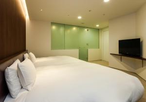 沼津大和鲁内酒店客房内的一张或多张床位