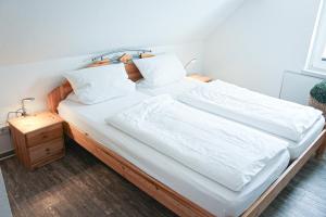 温特贝格Bergkrönchen Winterberg - Sauna - 8Beds - outdoor的一张配有白色床单和枕头的大床
