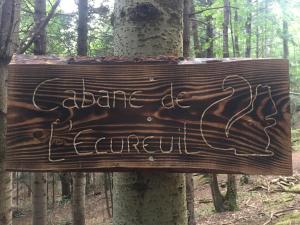 沙泰勒吉永cabane de l'Ecureuil的木头上的木头标志,上面写着