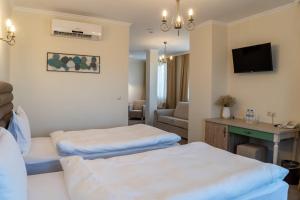 RazgradVilla Della Rosa的酒店客房配有两张床和一张书桌