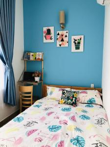 头顿HD House Homestay Vũng Tàu的一间卧室设有一张床和蓝色的墙壁