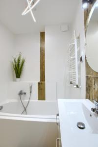 尤斯托尼莫斯基Apartamenty Wybrzeże Laguna II的白色的浴室设有浴缸和水槽。