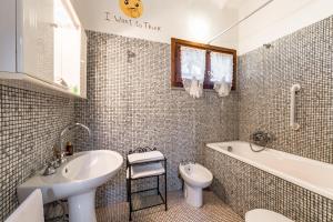 斯卡尔利诺Tortuga Casa Vacanze的一间带水槽、浴缸和卫生间的浴室
