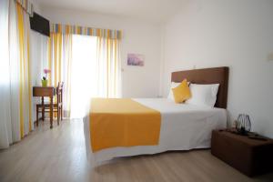 吉尔斯吉尔斯旅馆的一间卧室配有一张黄色和白色的大床