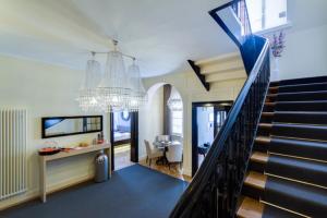 曼海姆Die Villa的一间带楼梯和吊灯的客厅