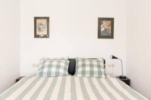 阿姆斯特丹Central Rooftop Terrace Guest Suite的卧室配有一张墙上有两张照片的床。