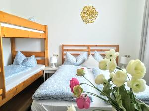 福森House LA Neuschwanstein Blick的一间带两张床的卧室和鲜花花瓶