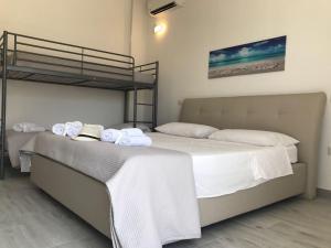 塔维亚诺B&B Corte Salentina的一间卧室配有双层床和毛巾
