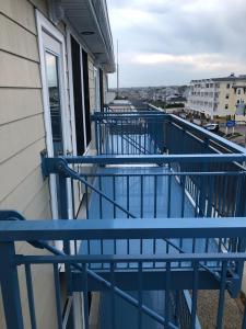 米斯奎米卡特Misquamicut Beach Front Inn的大楼内的阳台设有蓝色栏杆