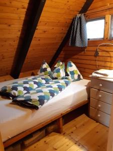 拉斯特Pfahlbau Rust Robinsonhütte的小木屋内一间卧室,配有一张床