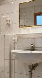 罗滕堡China Restaurant Hotel Lotus的浴室设有白色水槽和镜子