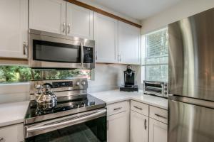 北湾Moon River Suites #5的厨房配有不锈钢用具和白色橱柜