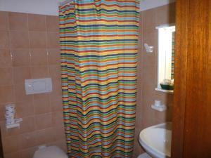 圣特雷莎加卢拉安科拉酒店的浴室里设有多彩的淋浴帘和卫生间